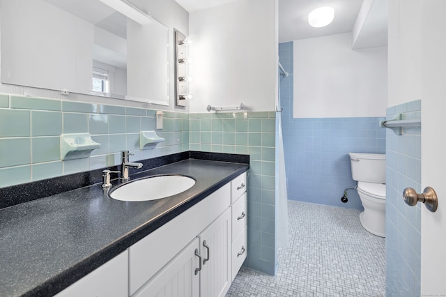 bathroom with vanity, toilet, tile patterned floors, a shower with shower curtain, and tile walls