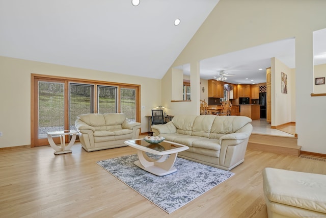living room with visible vents, baseboards, ceiling fan, high vaulted ceiling, and light wood finished floors
