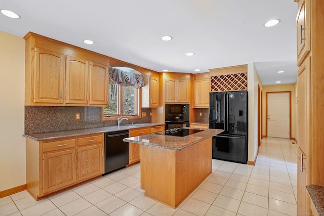 kitchen with a sink, stone countertops, decorative backsplash, a kitchen island, and black appliances