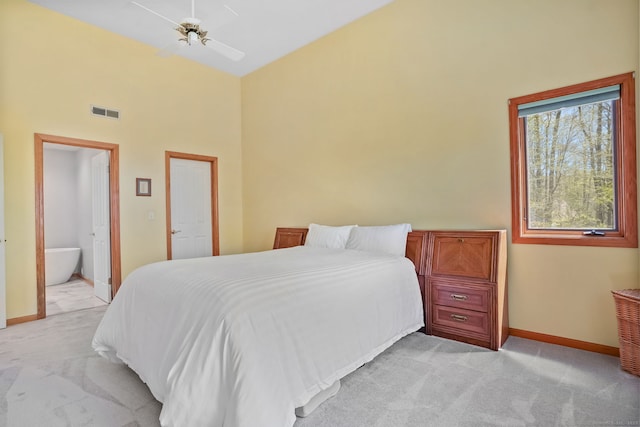 bedroom featuring light colored carpet, baseboards, a towering ceiling, and visible vents