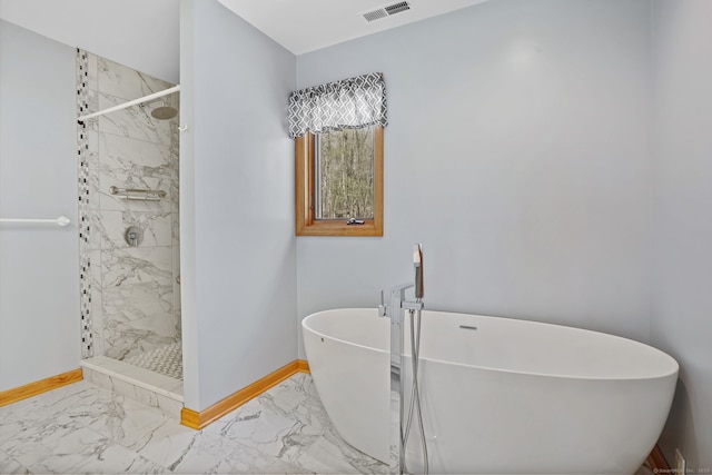 full bathroom with visible vents, marble finish floor, baseboards, a soaking tub, and a shower stall