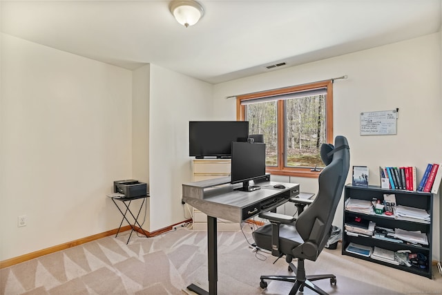 office featuring baseboards, visible vents, and carpet
