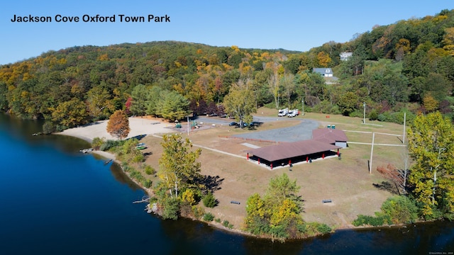birds eye view of property with a water view and a view of trees
