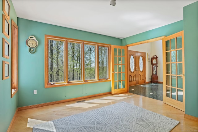 entrance foyer featuring baseboards, visible vents, and french doors