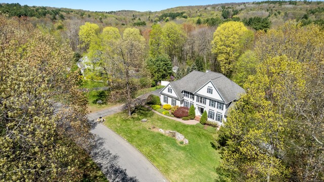 birds eye view of property with a wooded view