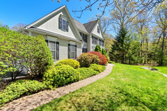 view of property exterior with a yard