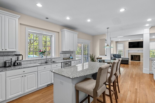 kitchen featuring a sink, tasteful backsplash, stainless steel dishwasher, and recessed lighting