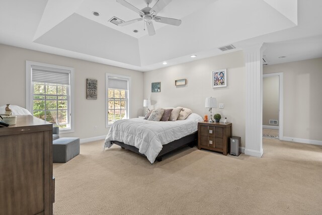 bedroom featuring baseboards, light colored carpet, and visible vents