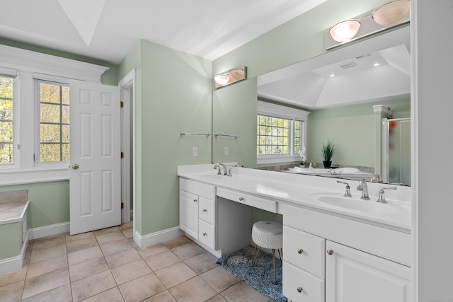 bathroom featuring a sink, tile patterned floors, baseboards, and double vanity