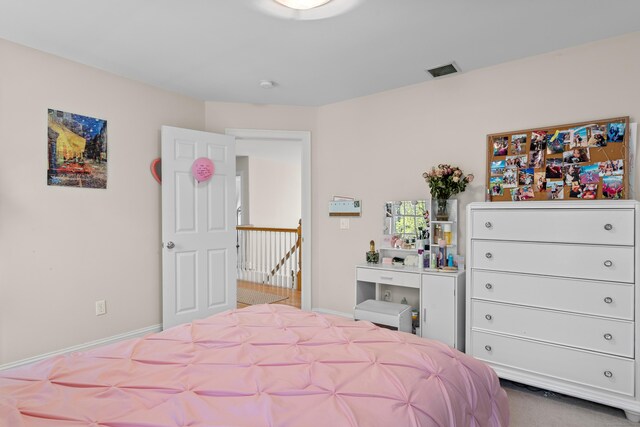 bedroom with baseboards and visible vents