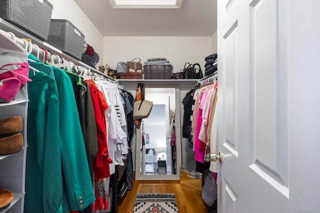 walk in closet with wood finished floors