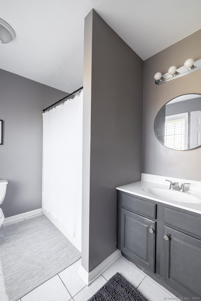 bathroom featuring vanity, baseboards, curtained shower, and toilet
