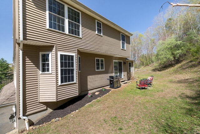 back of house with a lawn