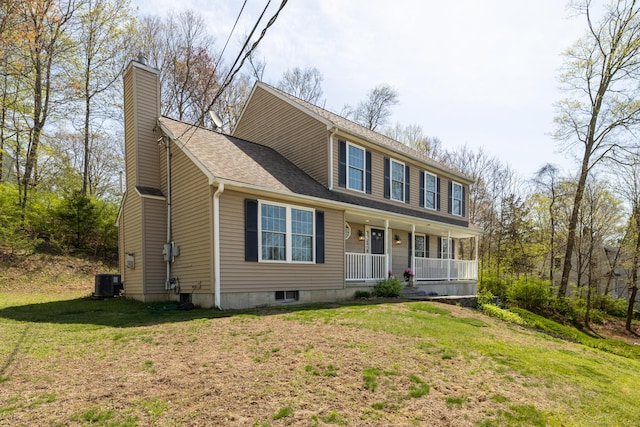 colonial-style house with central AC unit, a front lawn, covered porch, and a chimney