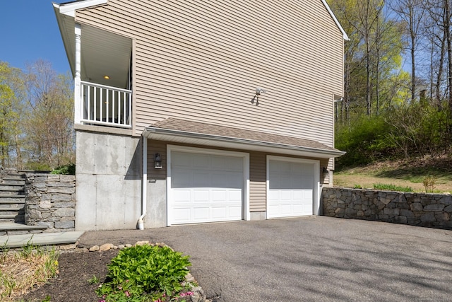garage featuring aphalt driveway