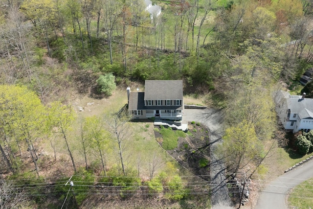 drone / aerial view with a wooded view