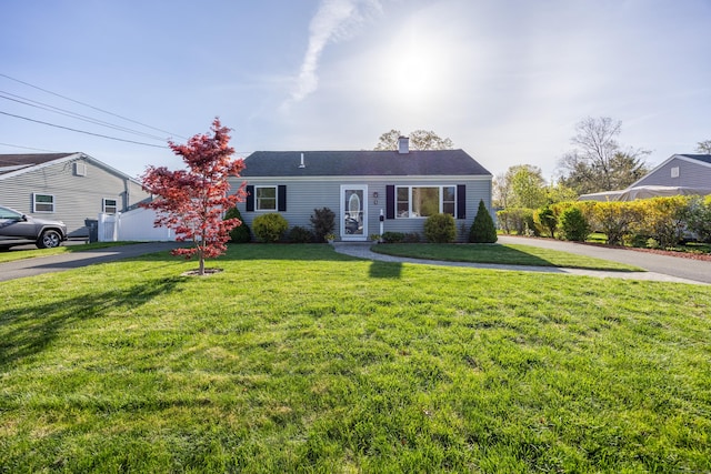 view of front of house with a chimney and a front yard