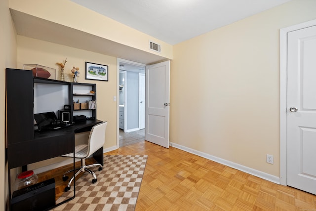 home office featuring baseboards and visible vents