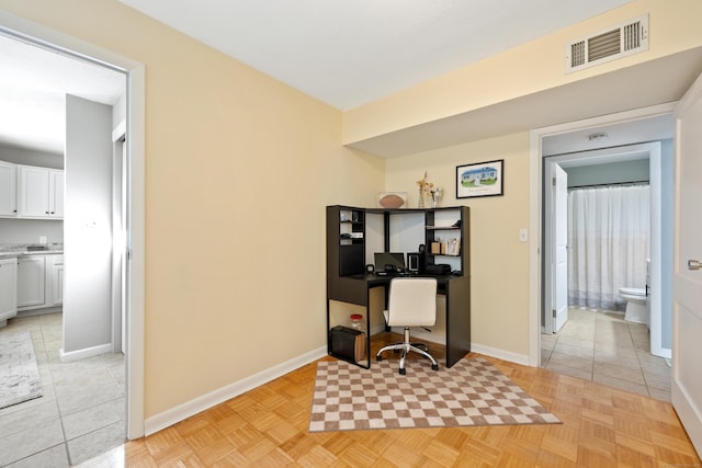 home office featuring baseboards and visible vents