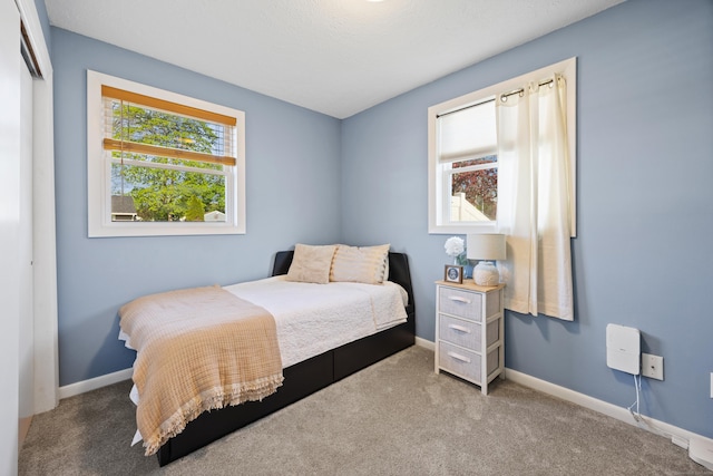 carpeted bedroom with baseboards