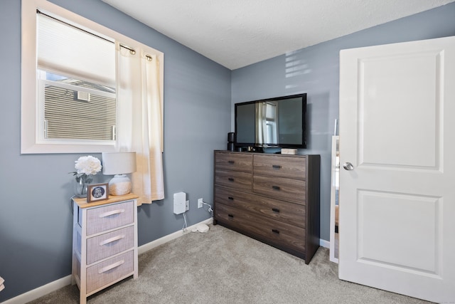 bedroom featuring baseboards and carpet