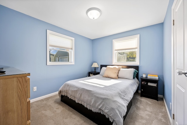 bedroom with baseboards and carpet