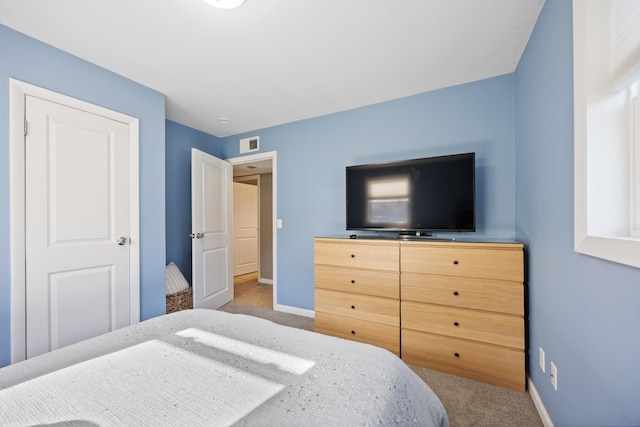 carpeted bedroom featuring baseboards and visible vents
