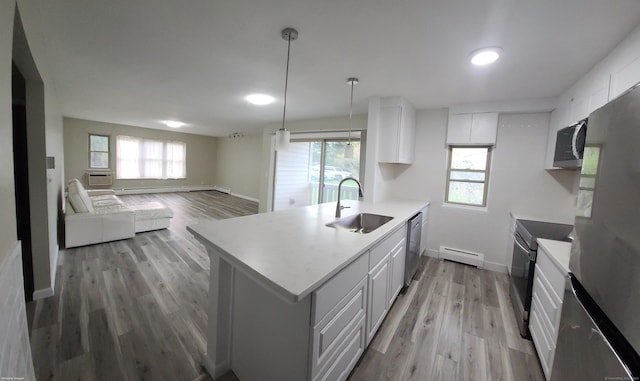 58 Henry St Unit 58, Norwich, CT 06360 - kitchen with a sink, a baseboard radiator, appliances with stainless steel finishes, baseboards, and light wood-type flooring