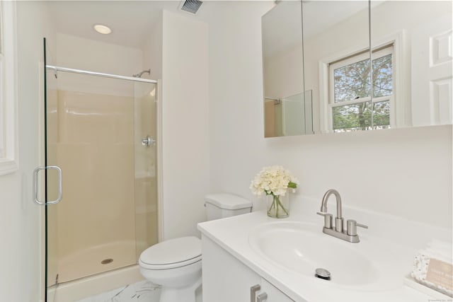 full bathroom with vanity, a stall shower, toilet, and visible vents