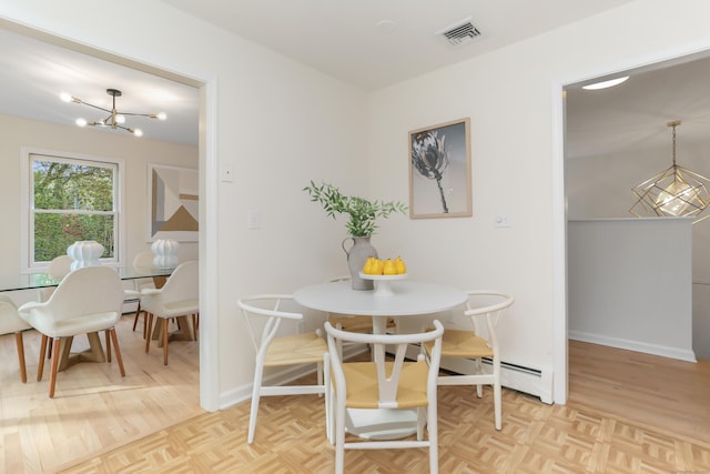 dining space with visible vents, baseboards, a baseboard heating unit, and a notable chandelier