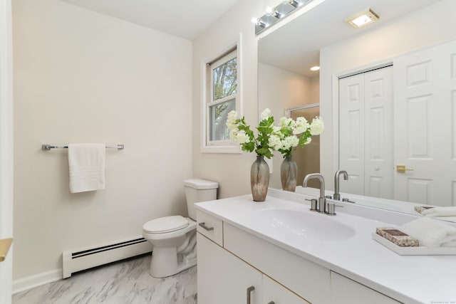 bathroom with vanity, marble finish floor, toilet, baseboards, and baseboard heating