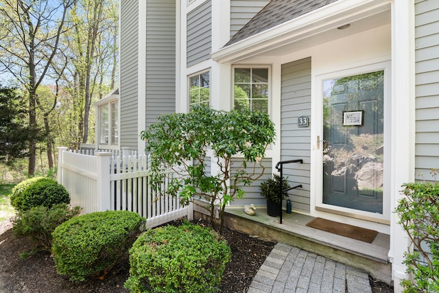 33 Hale Ln Unit 33, Darien, CT 06820 - view of exterior entry with fence and a shingled roof
