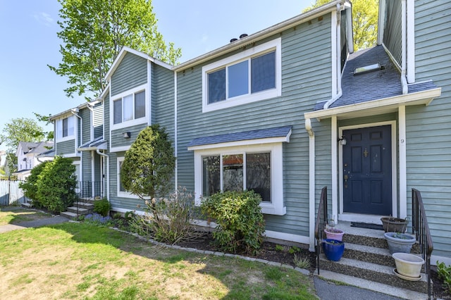 view of property with entry steps and a front yard