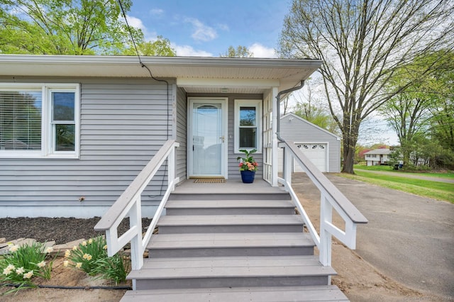 property entrance featuring a garage and driveway