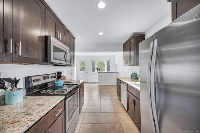 kitchen featuring light tile patterned flooring, dark brown cabinetry, light stone counters, stainless steel appliances, and recessed lighting