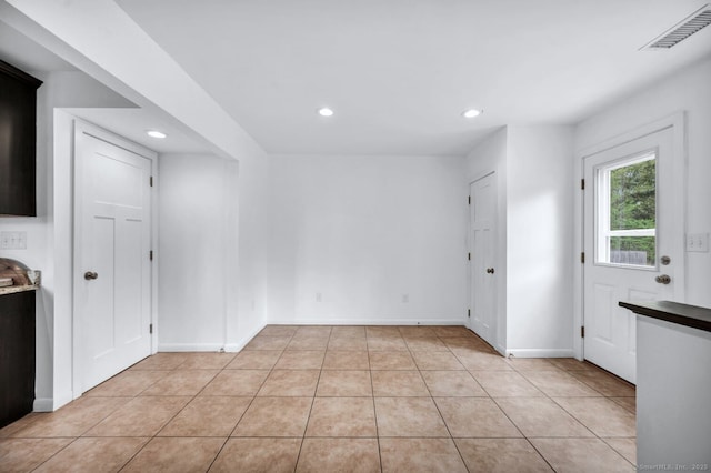 interior space with recessed lighting, baseboards, visible vents, and light tile patterned floors