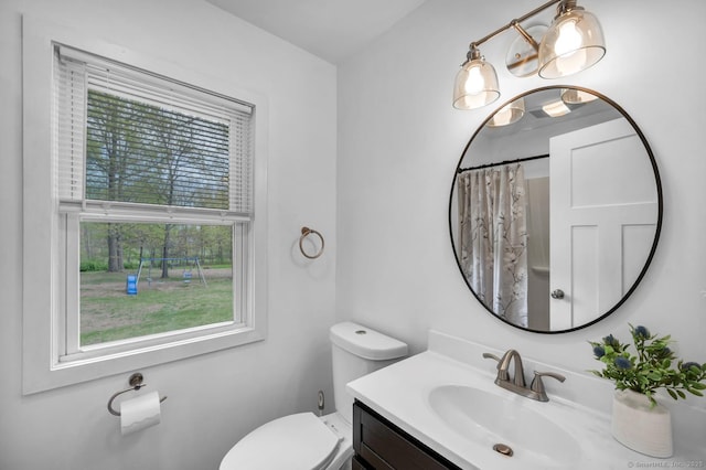 bathroom with vanity, toilet, and curtained shower