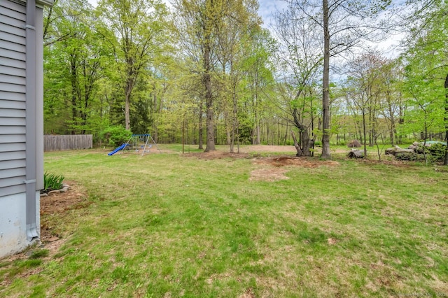 view of yard featuring a playground and fence