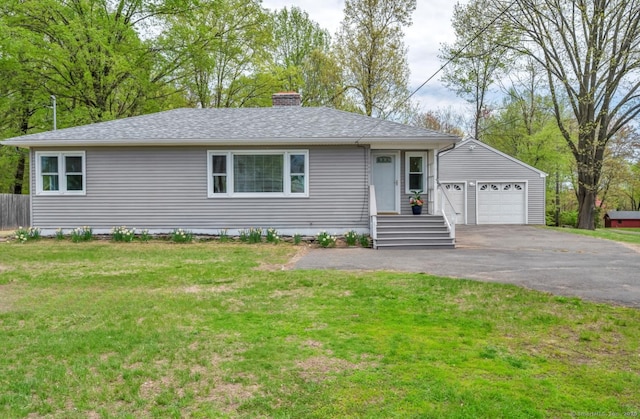 ranch-style house featuring a garage, a front yard, a chimney, a shingled roof, and driveway