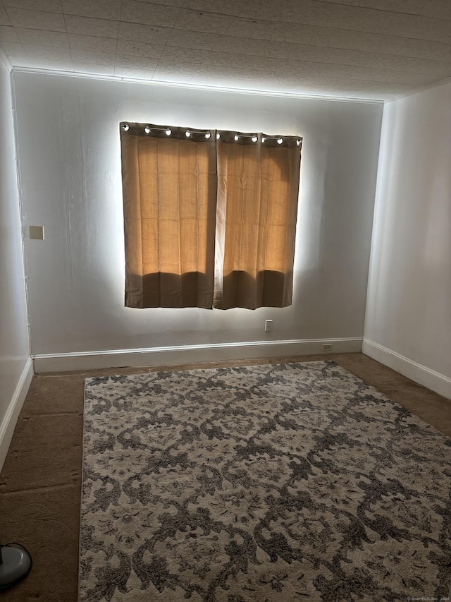 spare room featuring baseboards