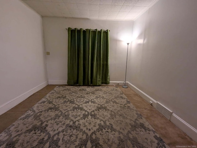 unfurnished room featuring visible vents, crown molding, and baseboards