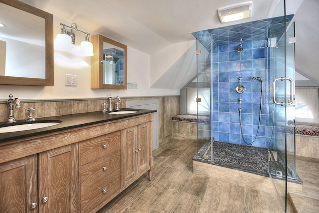 53 Sylvan Rd N, Westport, CT 06880 - full bathroom featuring a stall shower, tile walls, wood finished floors, double vanity, and a wainscoted wall