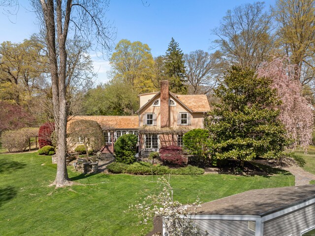 53 Sylvan Rd N, Westport, CT 06880 - view of front of house featuring a front yard and a chimney