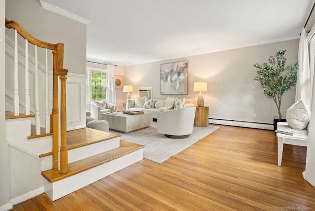living area featuring a baseboard heating unit, stairway, wood finished floors, ornamental molding, and an AC wall unit
