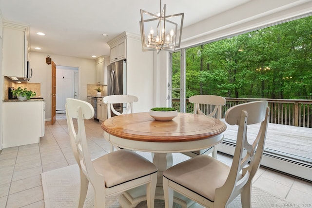 dining room with a chandelier, light tile patterned floors, recessed lighting, and a baseboard radiator