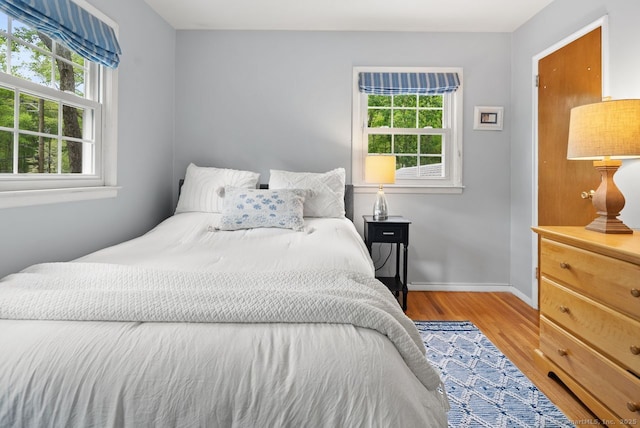 bedroom featuring wood finished floors and baseboards
