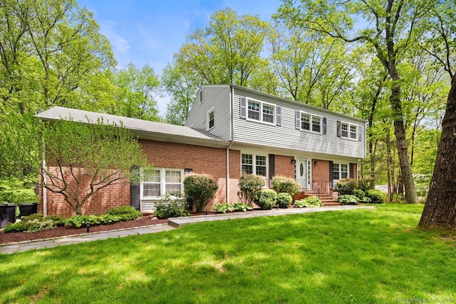view of front of property with brick siding and a front lawn