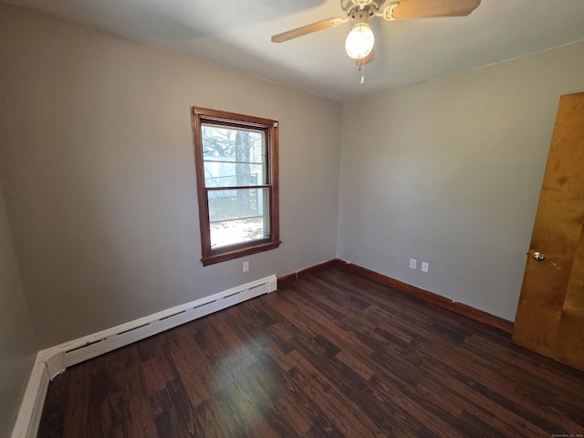 empty room featuring baseboards, ceiling fan, a baseboard heating unit, and dark wood finished floors