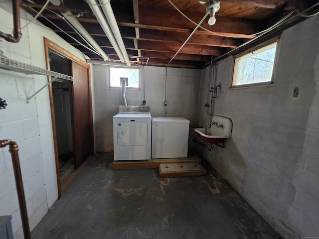 basement featuring a sink and washer and clothes dryer
