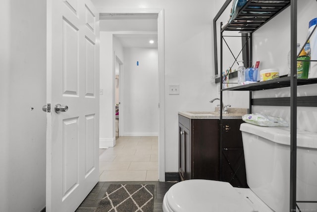 bathroom with vanity, tile patterned floors, and toilet